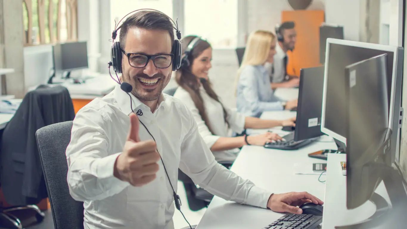 Man in call center giving thumbs up