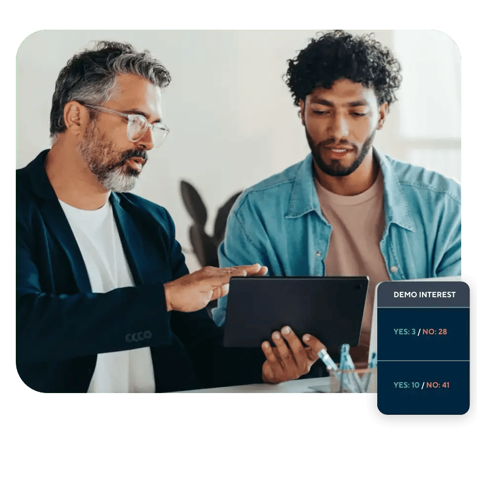 Two professionals discussing demo interest metrics on a tablet, with overlay highlighting low and high interest engagement rates.