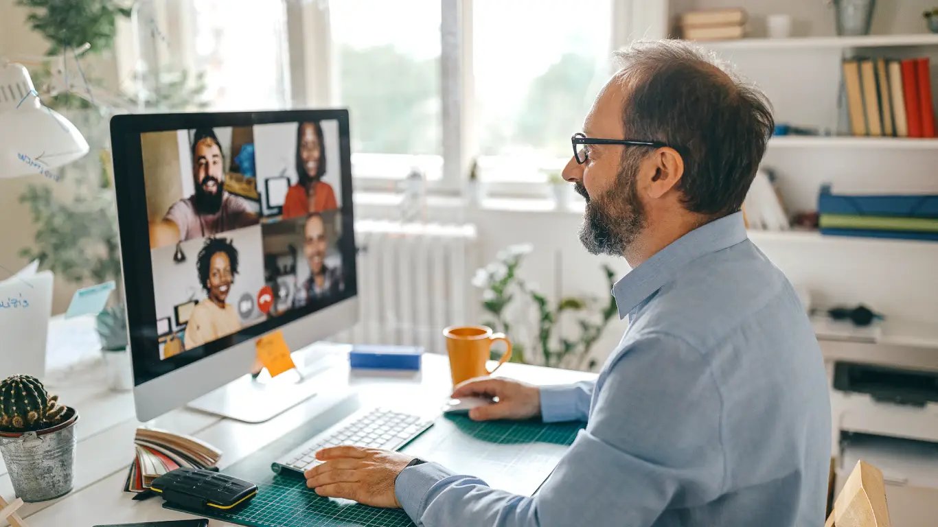 Man video conferencing with four people