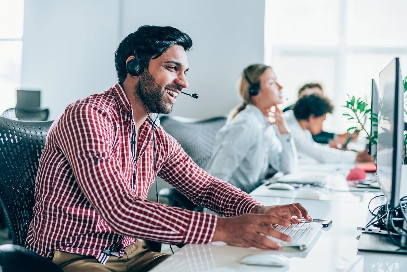 group-of-people-together-in-office-on-headsets