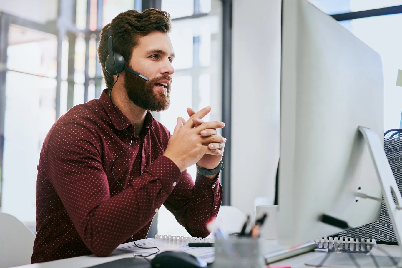 man-at-computer-talking-on-headset